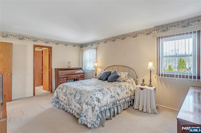 carpeted bedroom with baseboards