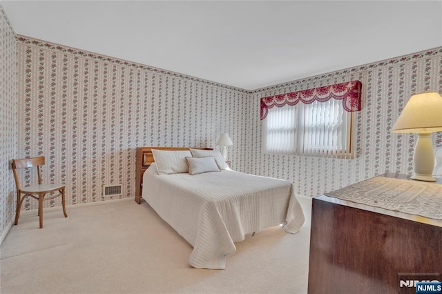 bedroom with light carpet, wallpapered walls, baseboards, and visible vents