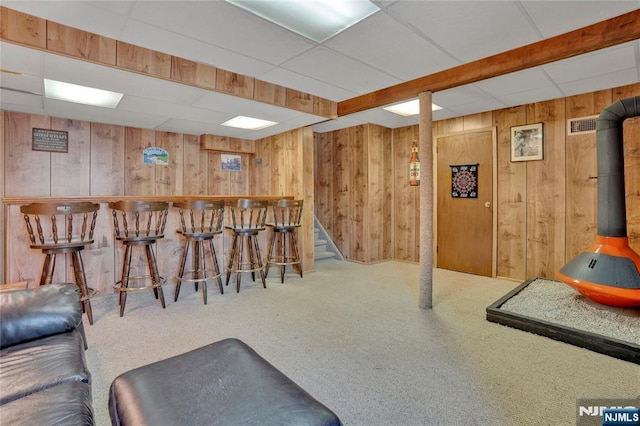 bar featuring a dry bar, wood walls, and carpet