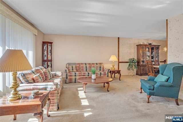 living room with wallpapered walls and carpet flooring