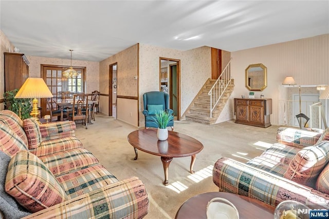 carpeted living area featuring stairway and wallpapered walls