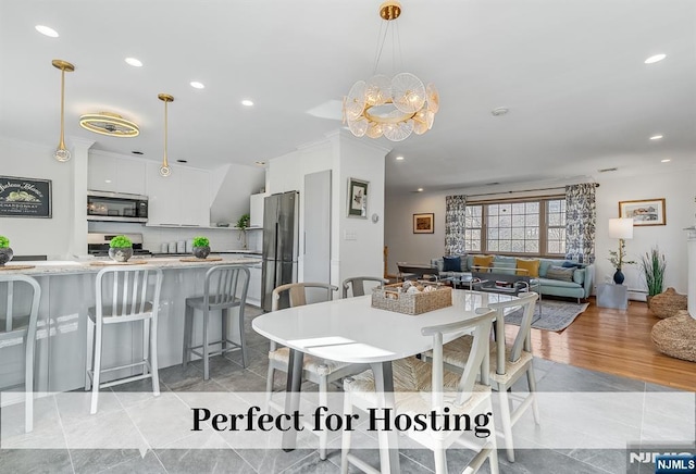 dining room with a notable chandelier and recessed lighting