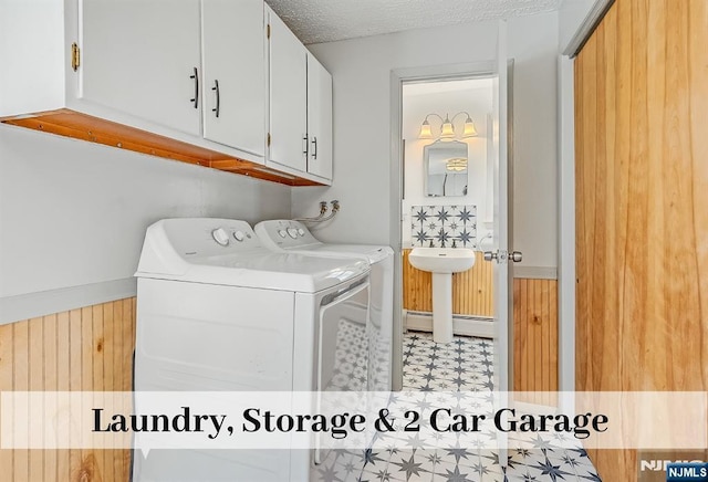 washroom with light floors, cabinet space, a baseboard heating unit, a textured ceiling, and independent washer and dryer