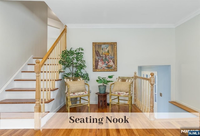 sitting room featuring baseboards, stairway, wood finished floors, and crown molding