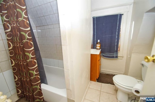 full bathroom featuring tile patterned flooring, vanity, toilet, and shower / bath combo with shower curtain