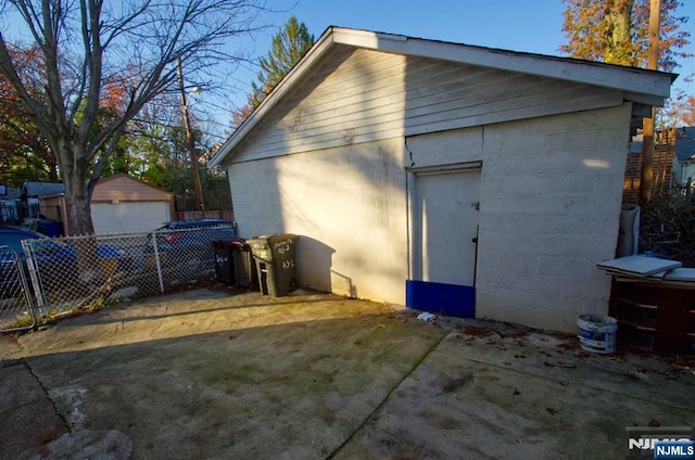 detached garage featuring fence