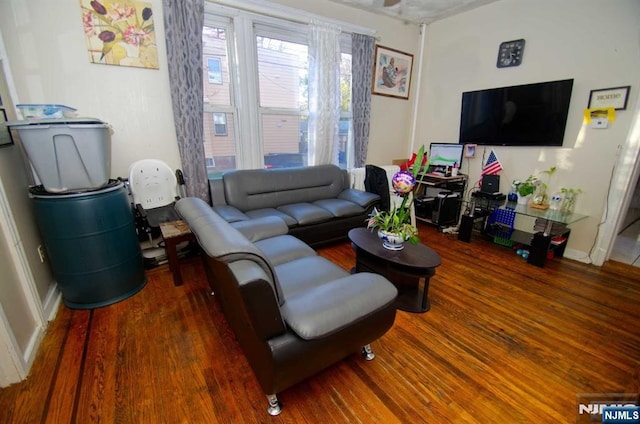 living room featuring baseboards and wood finished floors