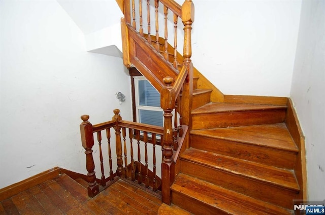 staircase featuring wood finished floors