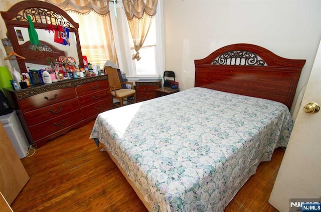 bedroom featuring dark wood finished floors