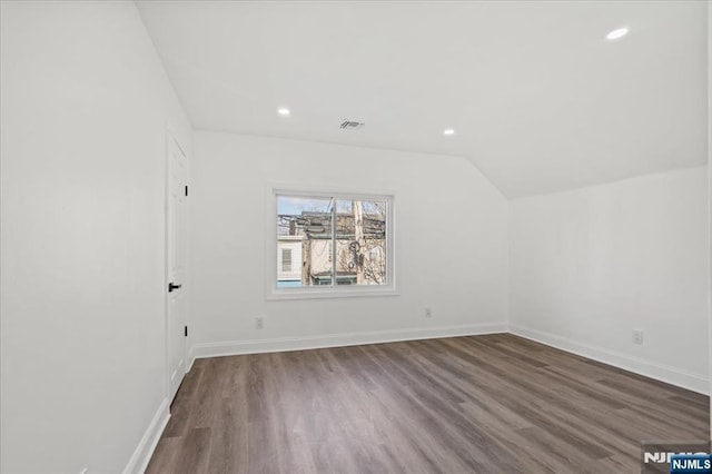 bonus room with vaulted ceiling, recessed lighting, wood finished floors, and baseboards