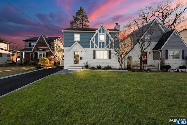 view of front of property with a yard and a chimney