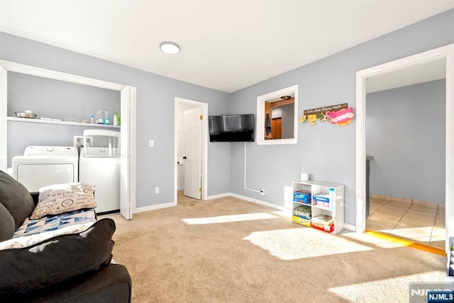 interior space with carpet flooring, separate washer and dryer, and baseboards