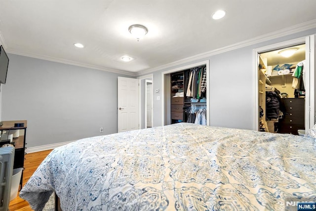 bedroom with baseboards, ornamental molding, and light wood finished floors