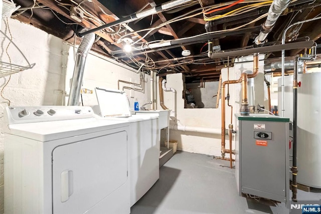 unfinished basement featuring separate washer and dryer, a heating unit, and water heater