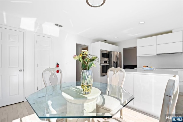 dining area with recessed lighting, visible vents, and light wood-style flooring