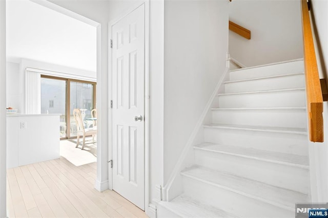 stairs with wood finished floors