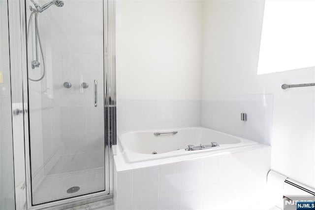 full bath featuring a stall shower, baseboard heating, and a bath