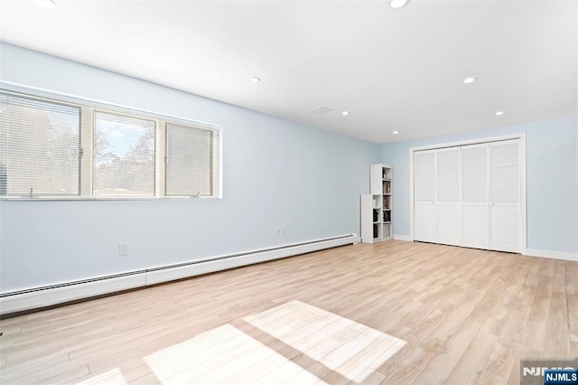 unfurnished bedroom with baseboards, a baseboard radiator, light wood-style floors, a closet, and recessed lighting