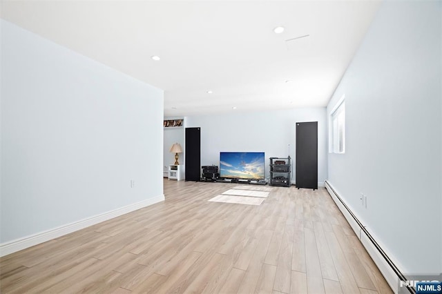 unfurnished living room with light wood-style floors, recessed lighting, baseboards, and baseboard heating