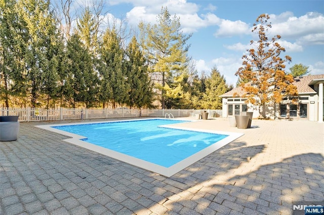 view of swimming pool with fence, a fenced in pool, and a patio