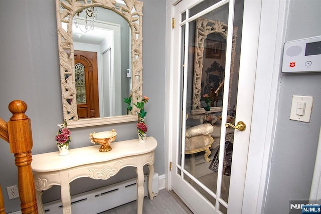 interior space with a baseboard radiator and wood finished floors