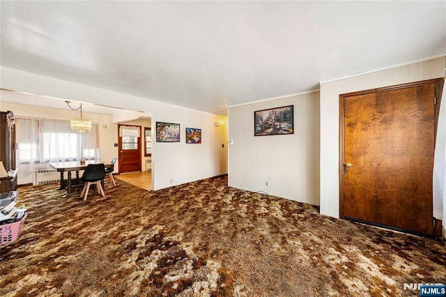 living area featuring a chandelier and carpet floors