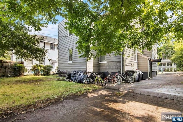 view of property exterior with a lawn