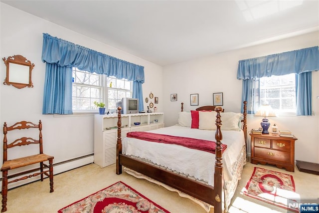 bedroom featuring baseboard heating and carpet flooring