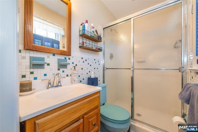 full bathroom featuring tile walls, a stall shower, toilet, and vanity