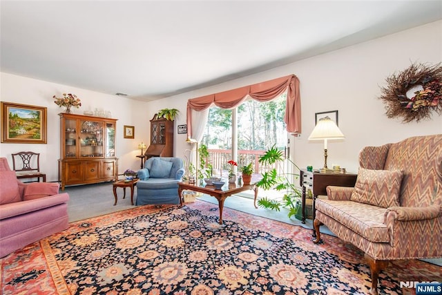 carpeted living room featuring visible vents