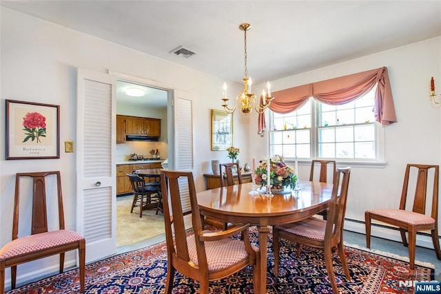 dining room featuring an inviting chandelier and visible vents