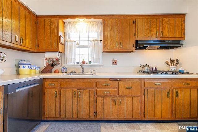 kitchen featuring under cabinet range hood, brown cabinets, stainless steel appliances, and a sink