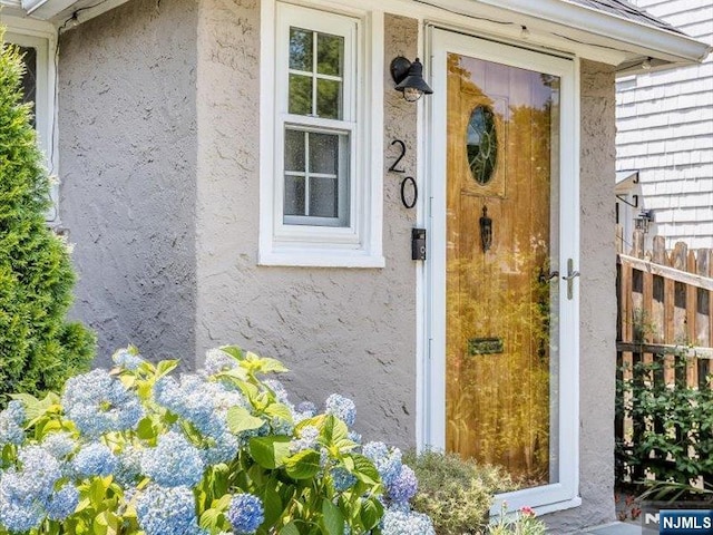 doorway to property with stucco siding