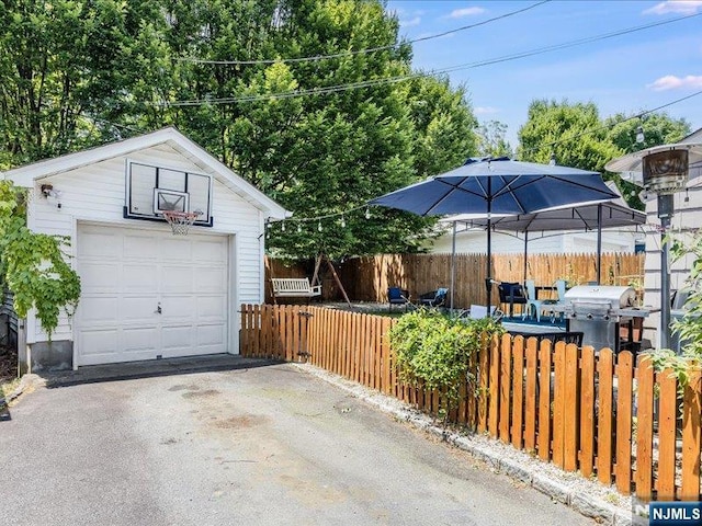 exterior space featuring driveway and fence