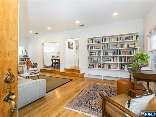 sitting room featuring wood finished floors, visible vents, and recessed lighting