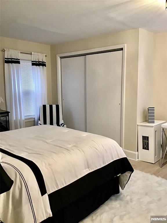 bedroom with a closet and baseboards