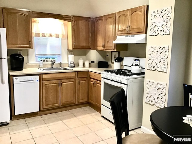 kitchen with white appliances, light countertops, a sink, and under cabinet range hood