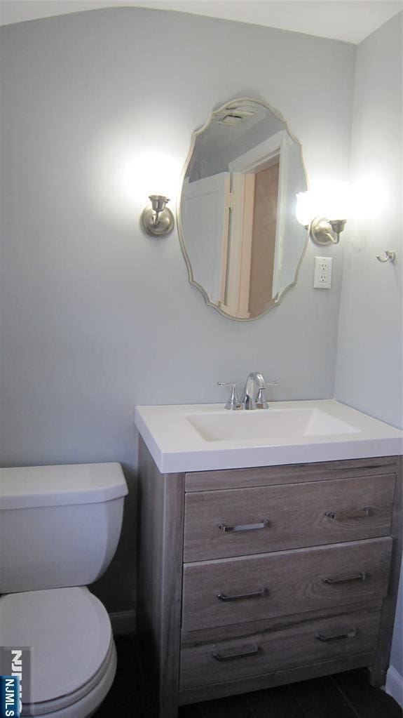 bathroom with tile patterned flooring, vanity, and toilet