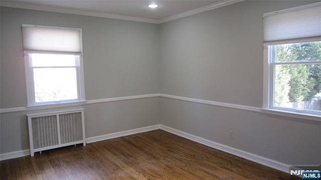 empty room with recessed lighting, baseboards, ornamental molding, radiator, and dark wood-style floors