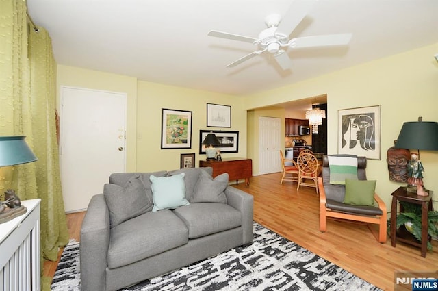 living room featuring ceiling fan and light wood-style flooring