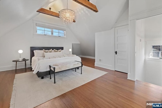 bedroom with vaulted ceiling with beams, an inviting chandelier, baseboards, and wood finished floors