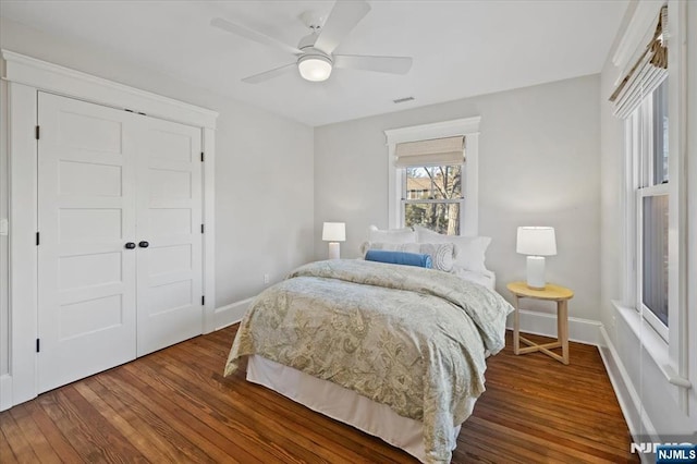 bedroom with a ceiling fan, a closet, baseboards, and wood finished floors