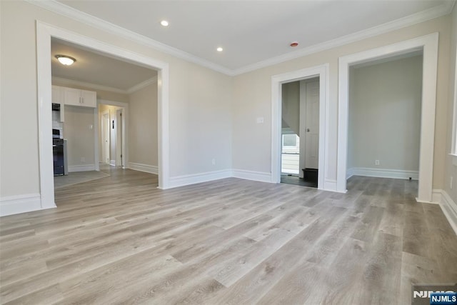 unfurnished room featuring ornamental molding, recessed lighting, light wood-style flooring, and baseboards