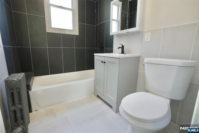 full bathroom with radiator heating unit, tile patterned flooring, toilet, and a healthy amount of sunlight