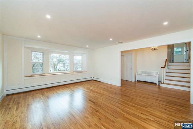 unfurnished living room with a chandelier, a baseboard radiator, visible vents, light wood-type flooring, and radiator