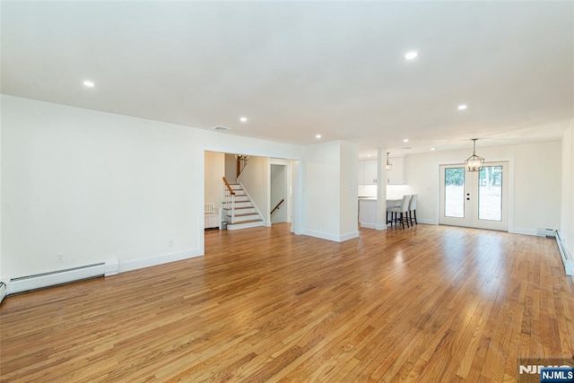 unfurnished living room with light wood finished floors, visible vents, baseboards, french doors, and recessed lighting