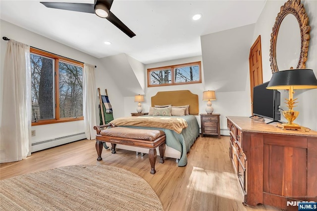 bedroom featuring light wood-style floors, recessed lighting, baseboard heating, and a ceiling fan