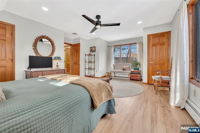 bedroom with a baseboard radiator, recessed lighting, visible vents, light wood-style floors, and baseboards