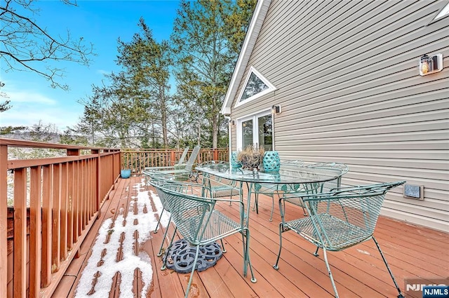 wooden deck featuring outdoor dining space