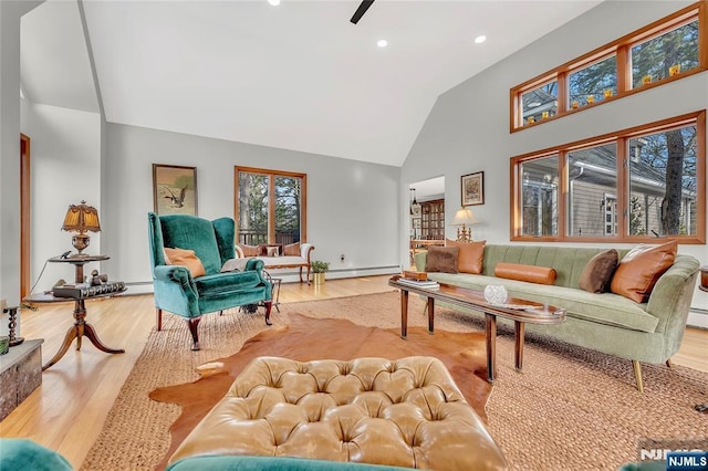 living room with light wood-style floors, recessed lighting, and high vaulted ceiling